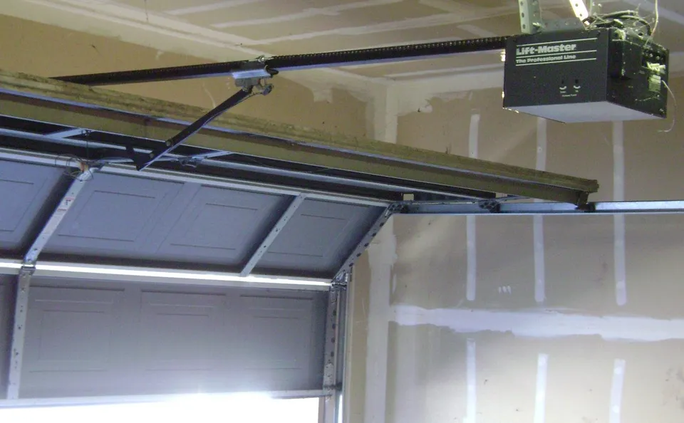 Ceiling-mounted garage-door opener with its rail
